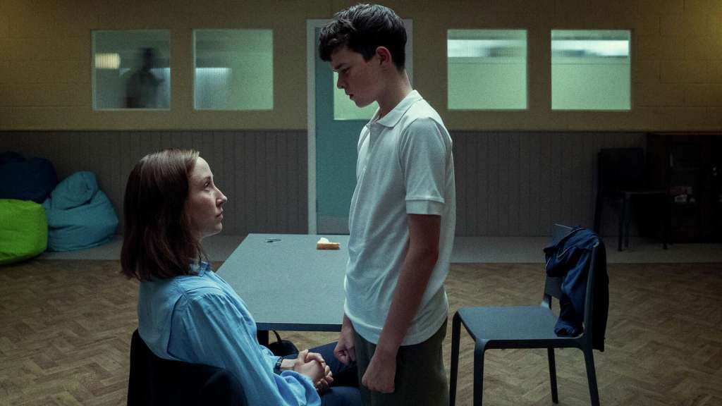"Erin Doherty as Briony Ariston and Owen Cooper as Jamie Miller share an emotional moment in a secure facility in Netflix’s Adolescence series."